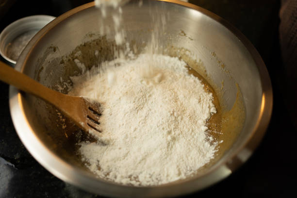 istock Adding Flour to the Chocolate Chip Cookie Ingredient Mix 1675130196