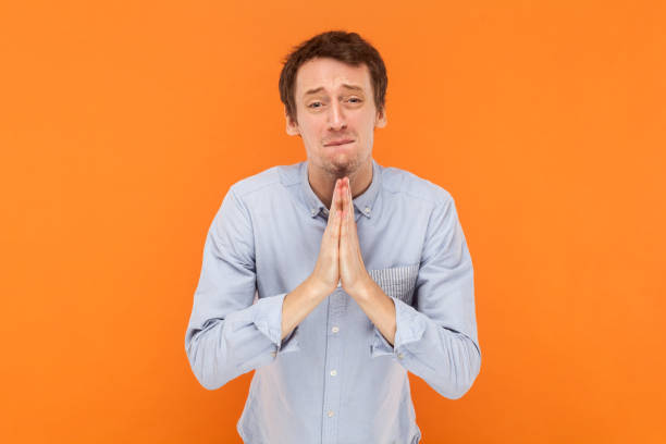 istock Hopeful handsome man standing asking to forgive, pleading, looking at camera with pout lips. 1675139421