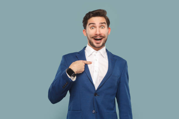 istock Excited amazed handsome man with mustache standing pointing at himself with surprised face. 1675146420