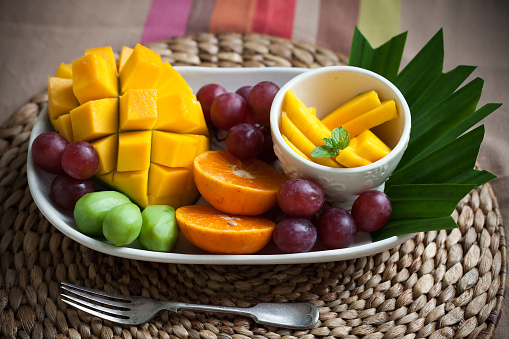 Fruits platter. A group of tropical fruits on traditional place matt. starts the day healthylifestye concept