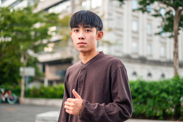 istock Confident young man showing thumb up sign 1675201098
