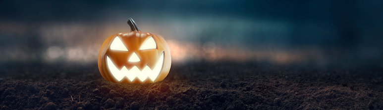 Jack O 'Lantern with creepy glowing eyes on Halloween night