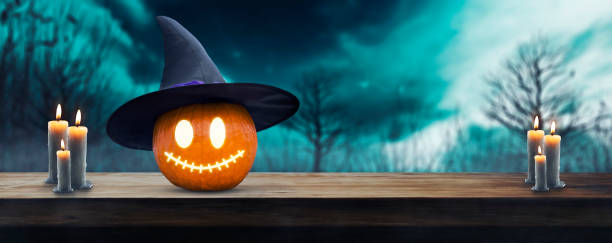 istock Jack O' Lantern on wooden table in spooky Halloween night with glowing eyes - copypaste 1675220816