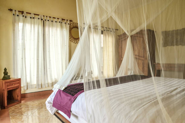istock Cozy canopy bed in bedroom with balcony 1675240295