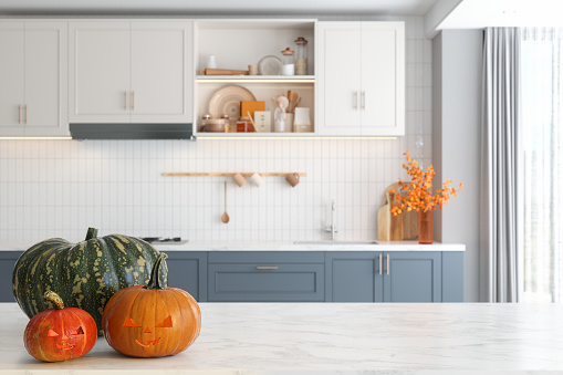Happy Halloween Concept With Curved Pumpkins On Empty Marble Kitchen Countertop