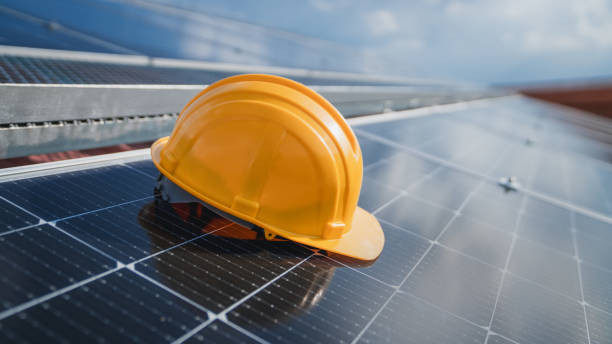 istock Yellow engineer hard safety helmet hat on solar cell panel. Solar panel and Clean energy concept. 1675300208