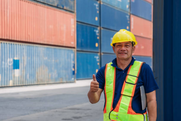 istock Portrait of Industrial Engineer show hand to success work at Container cargo harbor. Logistics Expert Overseeing Shipping and Distribution Operations. 1675304864