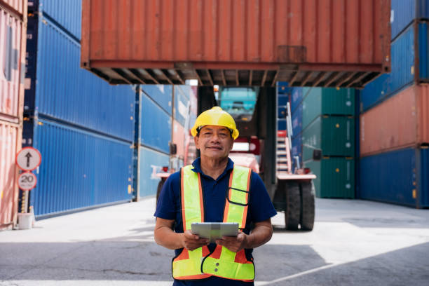 istock Portrait of Foreman checking inventory or task details at Container cargo harbor. Logistics concept inside the shipping, import, and export industries. 1675305114