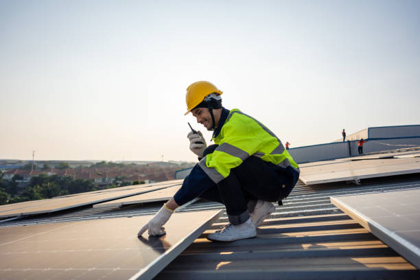 istock Professional engineer work to maintenance of photovoltaic panel system. Attractive technician worker working on roof inspect and check solar cell panels equipment box at solar cell field during sunset 1675306516