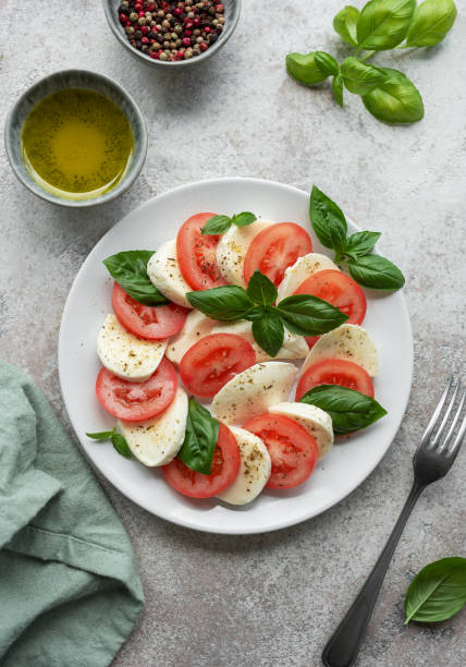istock Caprese salad with tomatoes, mozzarella and basil. 1675308073