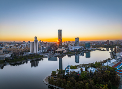 Yekaterinburg city and pond aerial panoramic view at summer or early autumn sunset. Night city in the early autumn. Yekaterinburg, Russia. Aerial view.