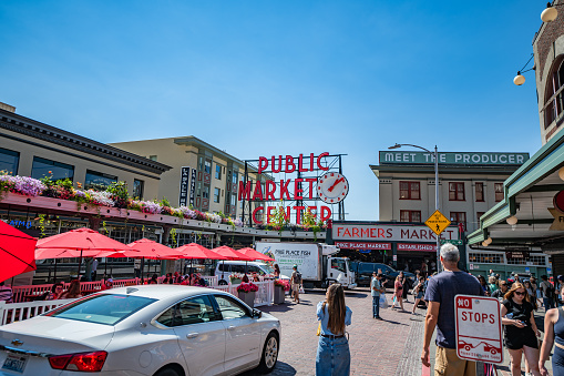 Pike Place Market as seen from Pike street on the sidewalk in Seattle, Washington on a clear sunny summer day