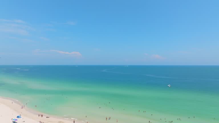 View from drone on endless Atlantic Ocean with beautiful clear water and sandy beach in Miami. Tourists relaxing and enjoying luxury exotic resort during summertime on South Beach