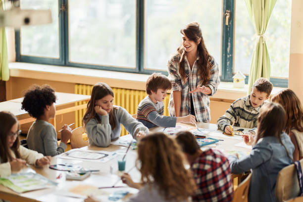 istock Happy teacher having an art class with her students at elementary school. 1675310920