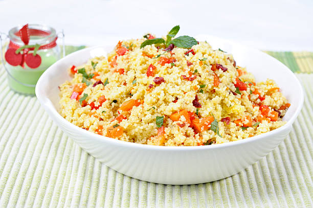 Couscous salad Couscous salad with carrots, red bell pepper, dried cranberries , mint and thyme in an orange and honey vinaigrette dressing couscous stock pictures, royalty-free photos & images