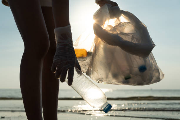 istock Save water. Volunteer pick up trash garbage at the beach and plastic bottles are difficult decompose prevent harm aquatic life. Earth, Environment, Greening planet, reduce global warming, Save world 1675338018