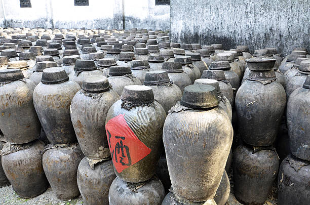Clay jars of wine made in the tradional way in china. the chinese charactor on the jar means wine.