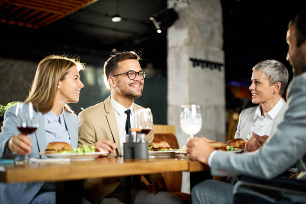 istock Happy business colleagues talking on a lunch in a restaurant. 1675366057