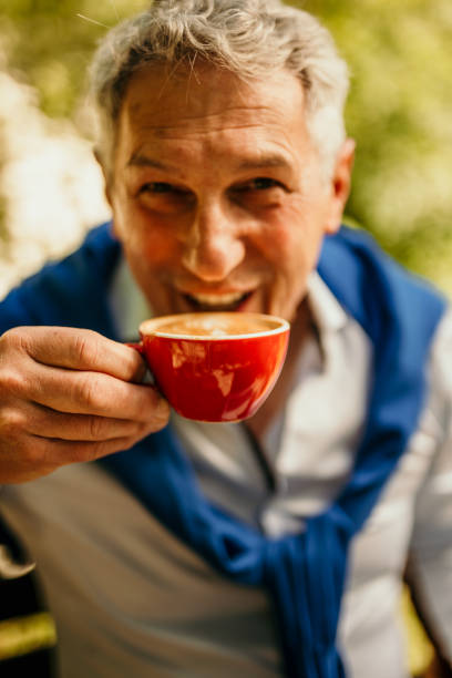 istock A businessman in a neatly pressed suit enjoys his morning coffee while efficiently managing his laptop tasks in the park 1675372365
