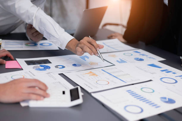 istock Group of  business hands with business financial documents. 1675374961