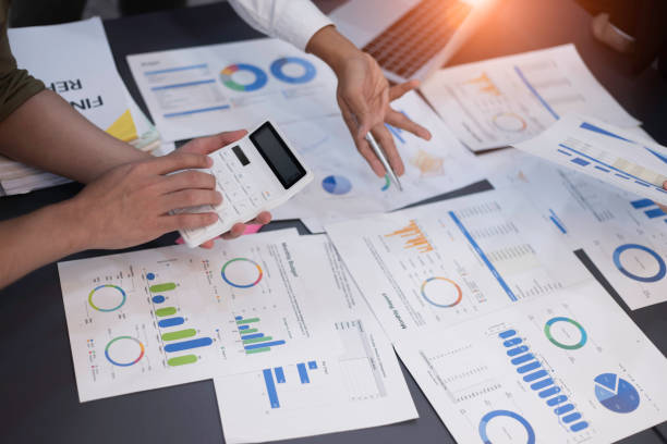 istock Group of  business hands with business financial documents. 1675374974
