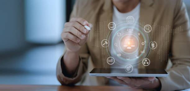 istock Lawyer hands holding digital tablet with law network interface icons. 1675374978