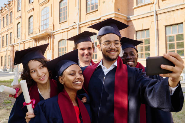 istock Graduated students having video call on smartphone 1675379754