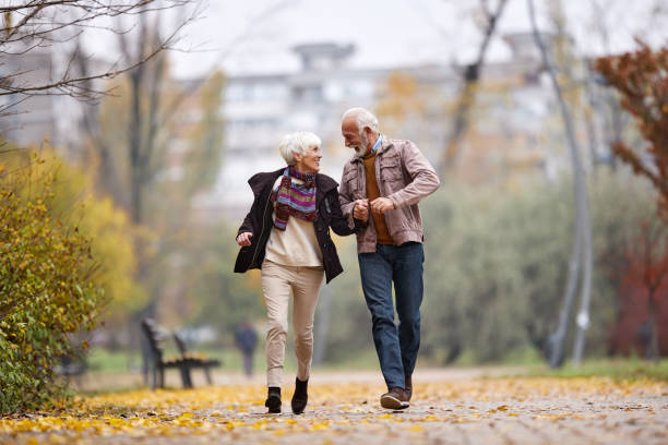 istock Playful senior couple having fun while running in the park. 1675380880