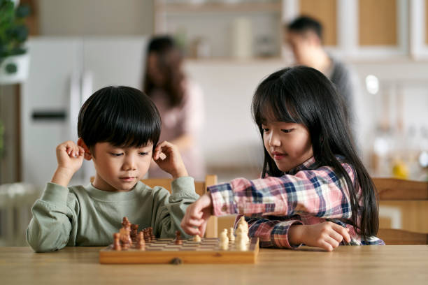 istock asian brother and sister playing chess at home 1675382506