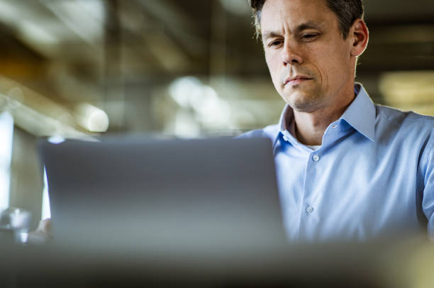 istock Mid adult businessman working on a computer in the office. 1675394628