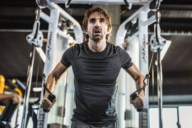 istock Determined athletic man exercising on a machine in a gym. 1675415704