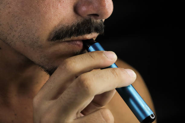 istock teenager smoking electric cigarette 1675420710