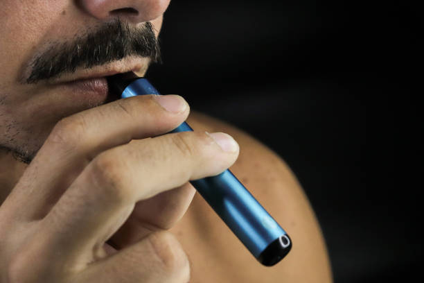 istock young boy smoking electric cigarrette 1675421091