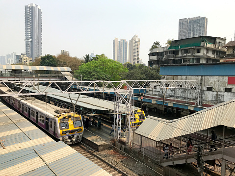 Suburban railway station in Mumbai of Western Railways with two local electric trains known as Life Line of Mumbai carrying thousands of commuters everyday.