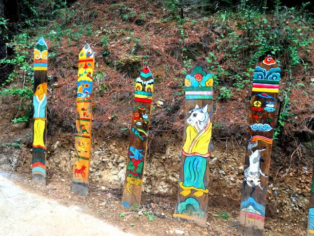 The brightly colored totem poles in the forest