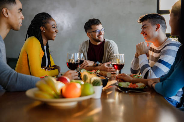 istock Happy friends enjoying in conversation during dinner at dining table. 1675433388