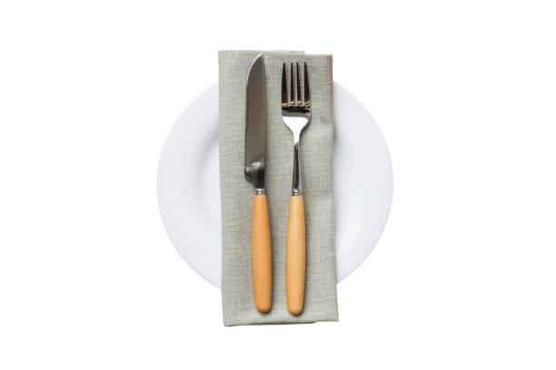 istock isolated christmas Plate with decor and fork and spoon. New year holiday background. Top view 1675449049