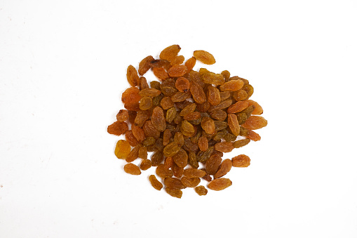 Dried golden raisins isolated on white background. Black Raisins or Kismis are a great snack option with good range of nutrients that can be added to the diet