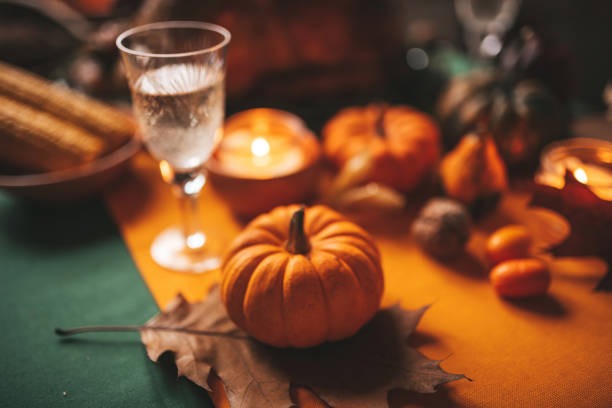 istock Thanksgiving holiday dinner table setting with fall decoration and pumpkins 1675458308
