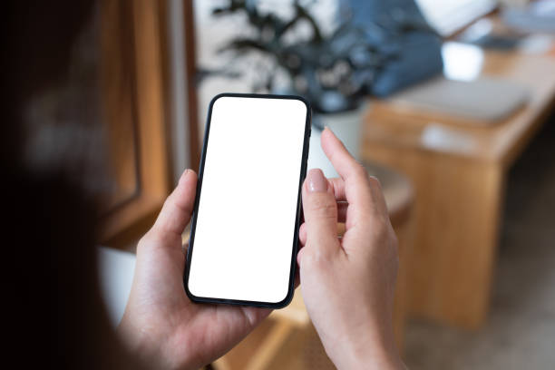 istock Mockup, woman's hand holding using mobile phone at coffee shop with copy space, white blank screen for text, mobile app design and advertsing, online marketing 1675470650