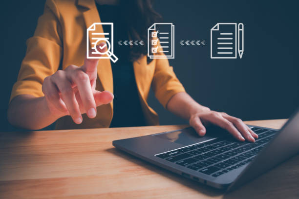 Businesswoman using computer laptop to tick mark on virtual screen and document for online approve paperless quality assurance and ERP management. Concept of Prepare check and online approval.