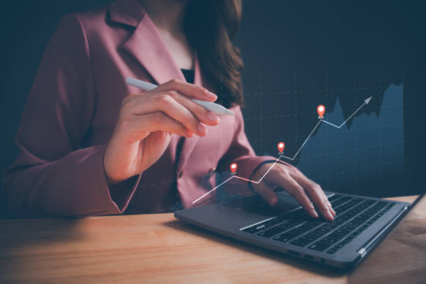 istock Businesswoman using computer laptop to analyze financial data chart  investing in stock markets. Concept of investment, trading forex, business finance technology, funds and digital assets. 1675477634