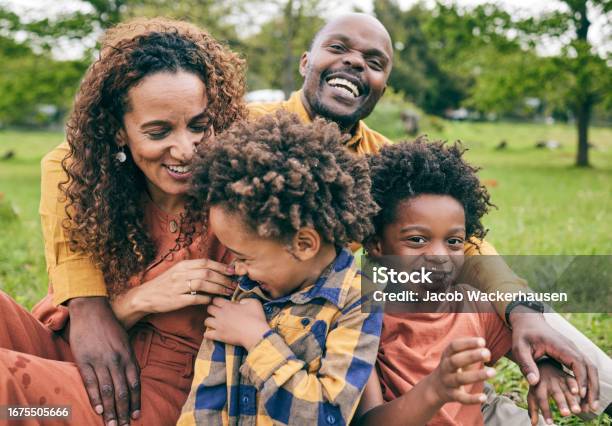 Happy Black Family Parents And Children In A Park In Summer Smile And Relax On Grass Field For Love And Fun In Nature Happiness Picnic And Portrait Of African People Outdoor And Playing Together Stock Photo - Download Image Now