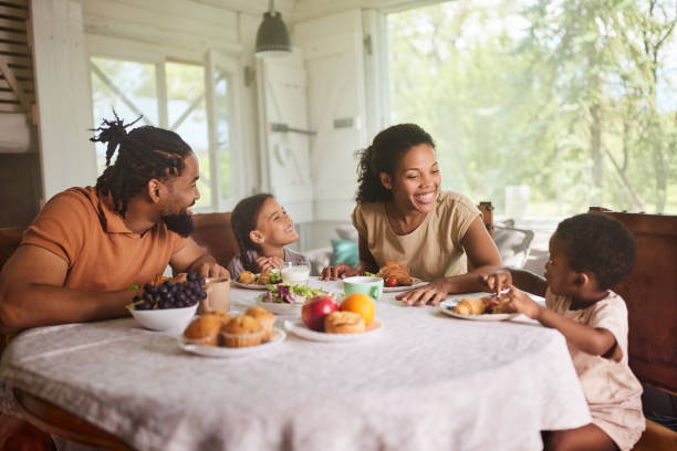 istock Happy black family talking during breakfast at dining table. 1675518089