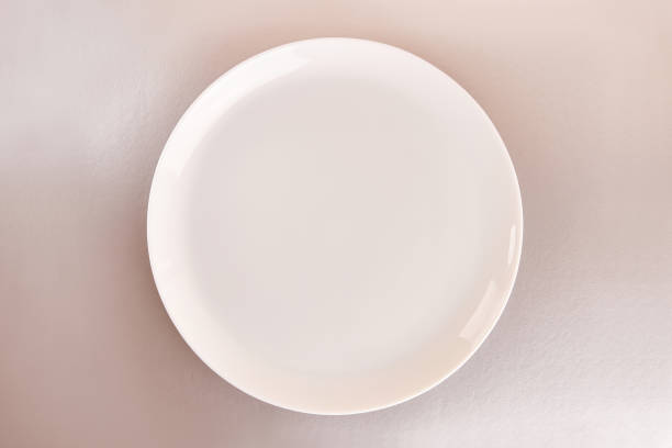 istock White plate on a gray background. Graphic background for designers. 1675520274