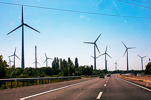 road through windmills. Energy saving. Global energy crisis. Ecological fuel