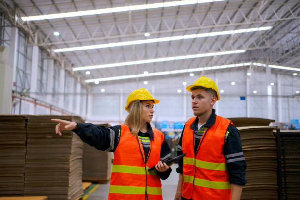 istock Blue collar worker work at cardboard box manufacturing factory. 1675547123
