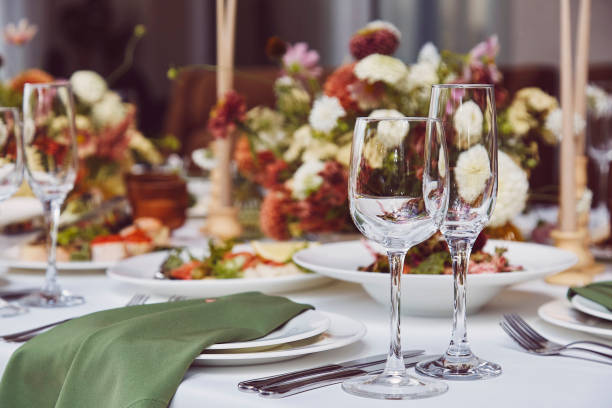istock Aesthetic stylish autumn table setting background, arranged flowers and candles under natural light. Cozy holidays table setup 1675560004