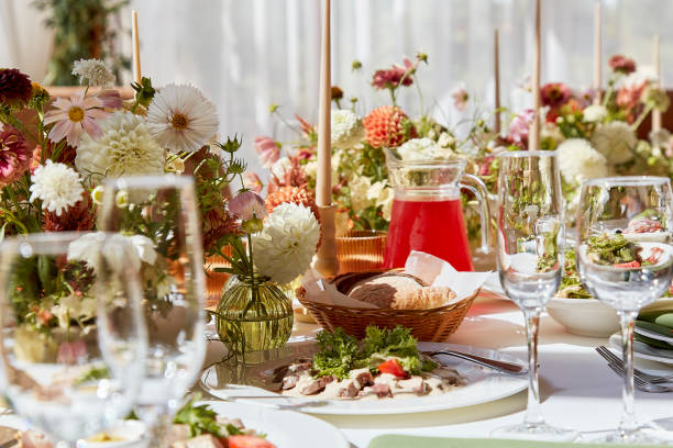 istock Restaurant autumn aesthetics table setting, flowers arrangement under sunlight shadows. Cozy setup with flowers and candles 1675560635