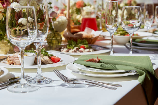 istock Table setting in elegant chamber is graced by candles and flowers arrangement casting sunlight shadows. The wedding embodies the aesthetics of Provence 1675561078